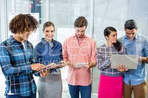 Executives using laptop, digital tablet and mobile phone