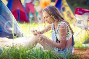 Woman using mobile phone at campsite