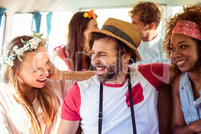 Group of friends having fun in campervan