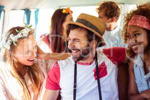 Group of friends having fun in campervan