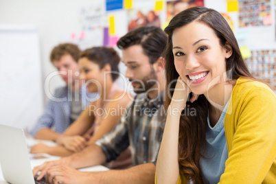 Portrait of smiling executive sitting in conference room with colleague