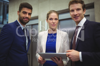 Portrait of businesspeople holding digital tablet