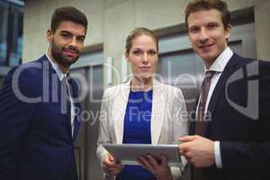 Portrait of businesspeople holding digital tablet