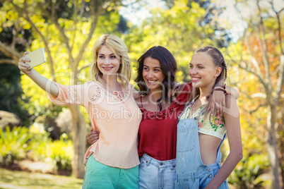 Friends taking selfie with mobile phone