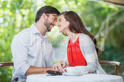 Happy couple leaning over to kiss