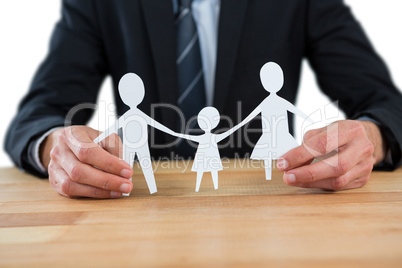 Mid section of businessman holding paper family