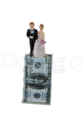 Wedding couple figurines on US dollar banknote