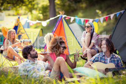 Group of friends having fun together at campsite