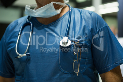 Mid section of male surgeon in scrubs