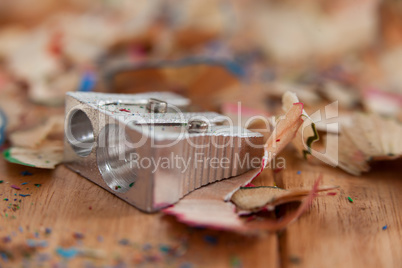 Sharpener and various colored pencil shavings