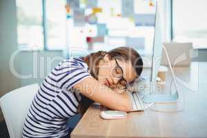 Female graphic designer sleeping on desk