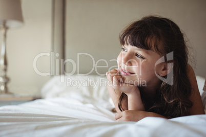 Siblings looking away in bed