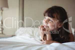 Siblings looking away in bed