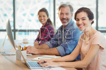 Team of graphic designers working together at desk