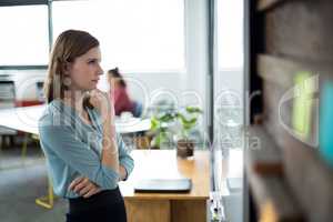 Attentive businesswoman looking at white board