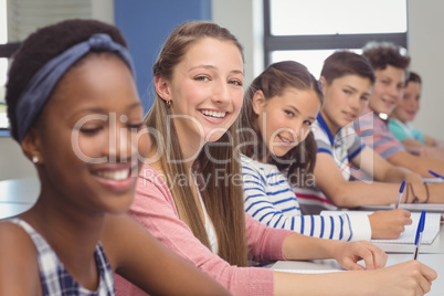 Students sitting at desk in classroom