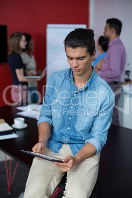 Business executive using digital tablet at meeting