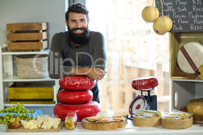 Portrait of happy salesman standing at counter
