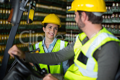 Factory workers interacting with each other in factory