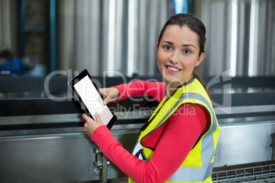 Female factory worker using digital tablet