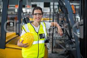 Portrait of female worker standing in factory