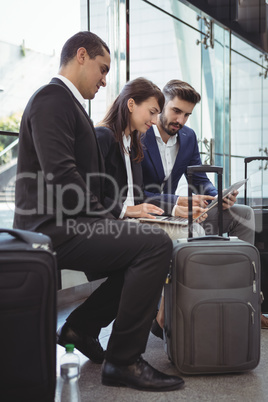 Business executives using laptop on platform