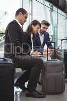 Business executives using laptop on platform