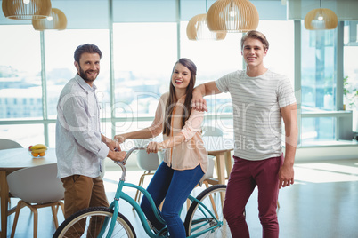 Portrait of business executives with bicycle