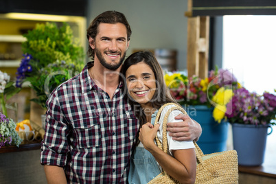 Happy couple standing in the florist shop