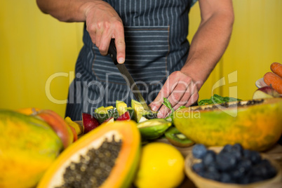 Staff chopping avocado at counter