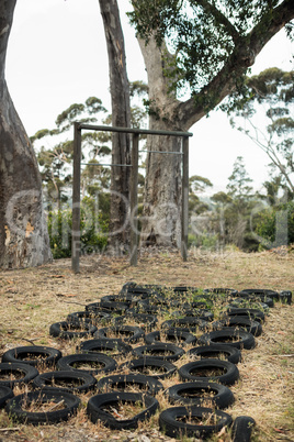 Tires placed in a row on ground for obstacle training course