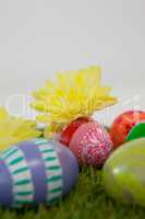 Painted easter eggs with flowers on grass