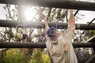 Soldier climbing monkey bars