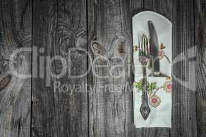 Table knife and fork on gray wooden surface