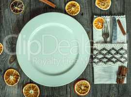 Served white empty plate on a gray wooden surface