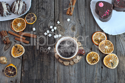cup of hot black coffee on a gray wooden surface