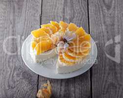 Cheesecake decorated with oranges and physalis