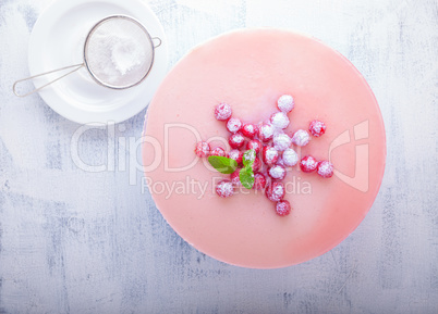 Raspberry yogurt cake with berries on a table.