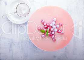 Raspberry yogurt cake with berries on a table.