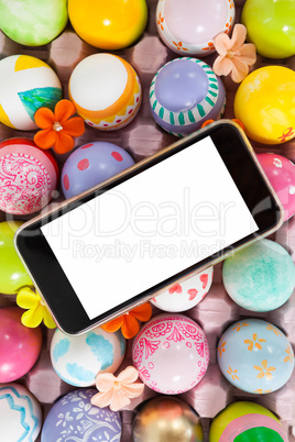 Mobile phone on painted easter eggs