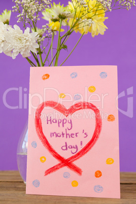Happy mothers day card with flower vase on table
