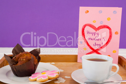 Happy mothers day greeting card with tea and snacks