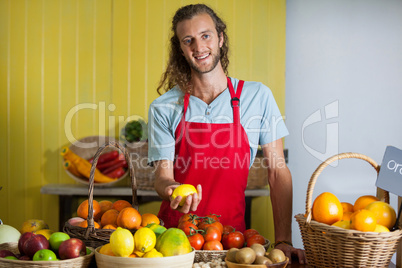 Portrait of smiling staff standing at counter