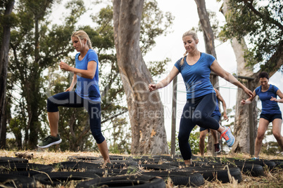 Women receiving tire obstacle course training