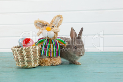 Easter eggs on wicker basket with Easter bunny and toy