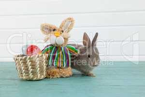 Easter eggs on wicker basket with Easter bunny and toy