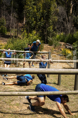 People passing through hurdles during obstacle course