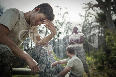 Tired man with hand on head sitting