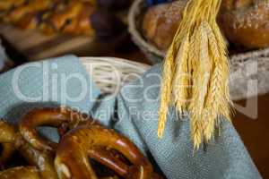 Ears of wheat and pretzel breads at counter