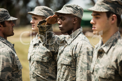 Military trainer giving training to military soldier